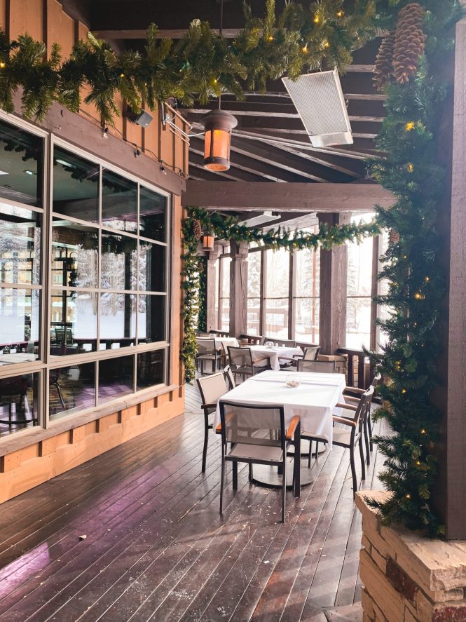 covered outdoor area with Christmas garland around wood beams