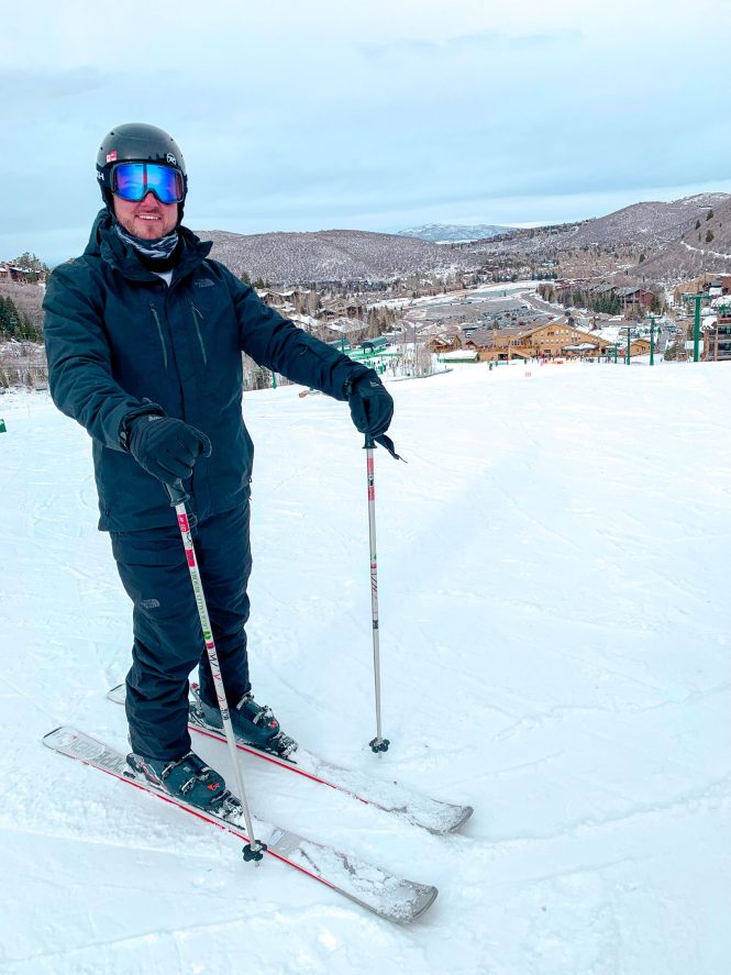 tall man in ski gear on snowy mountain in deer valley utah