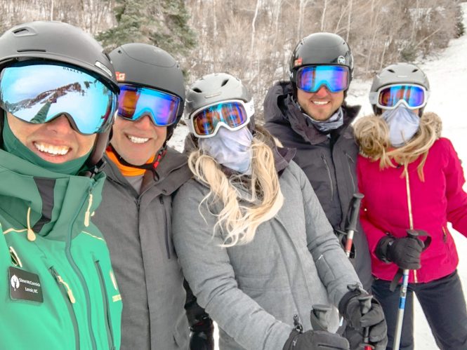 four friends and their ski instructor in ski gear and in the snow in deer valley, utah